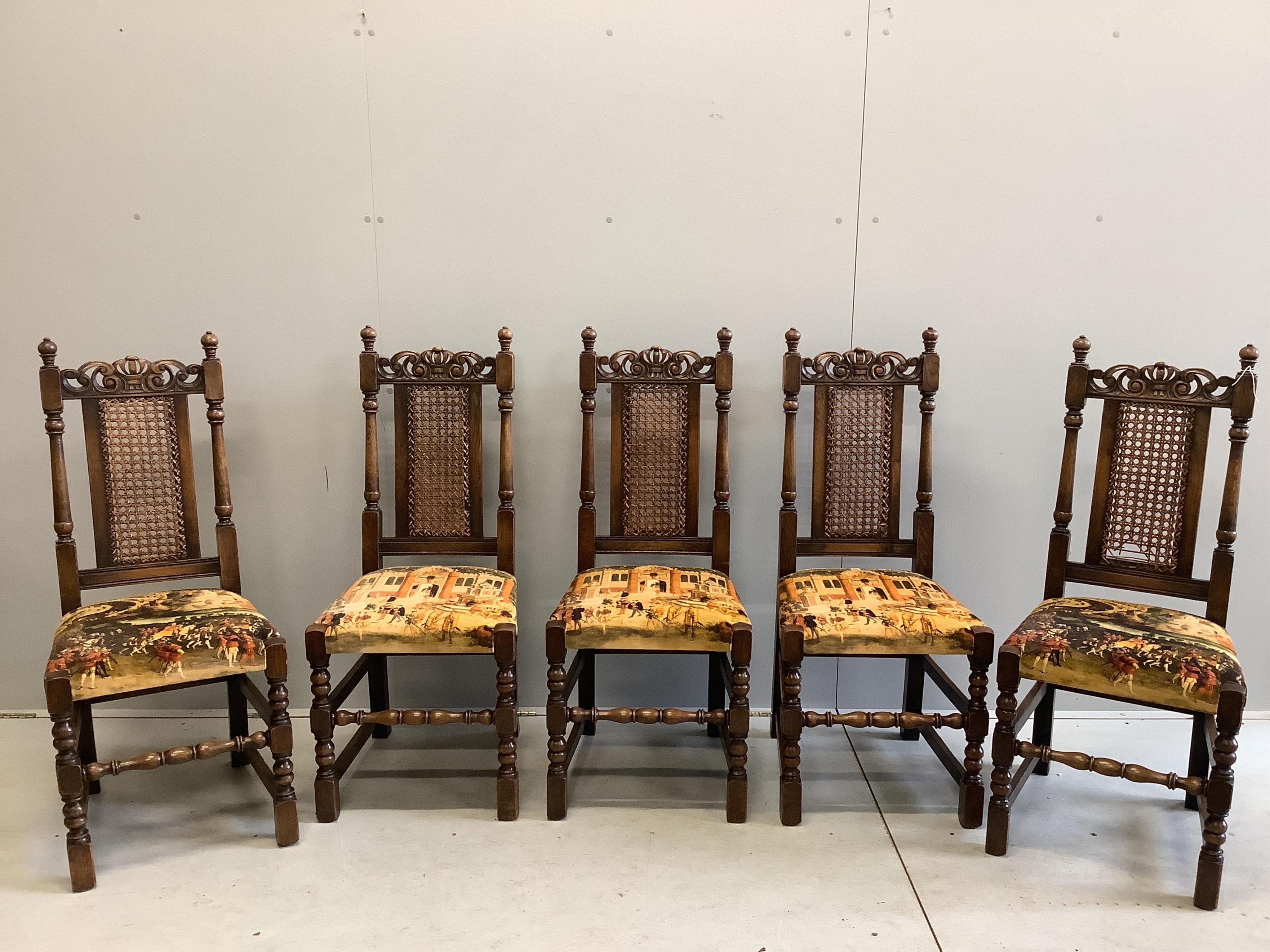 An 18th century style rectangular oak draw leaf refectory dining table, width 244cm extended, depth 85cm, height 79cm together with seven caned oak dining chairs, two with arms. Condition - fair to good